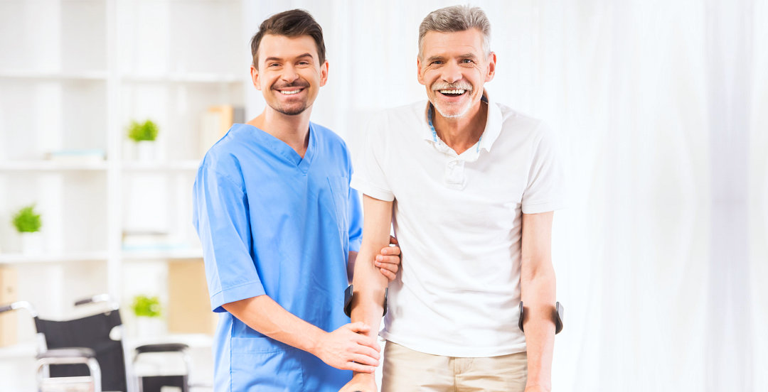nurse and elderly man smiling